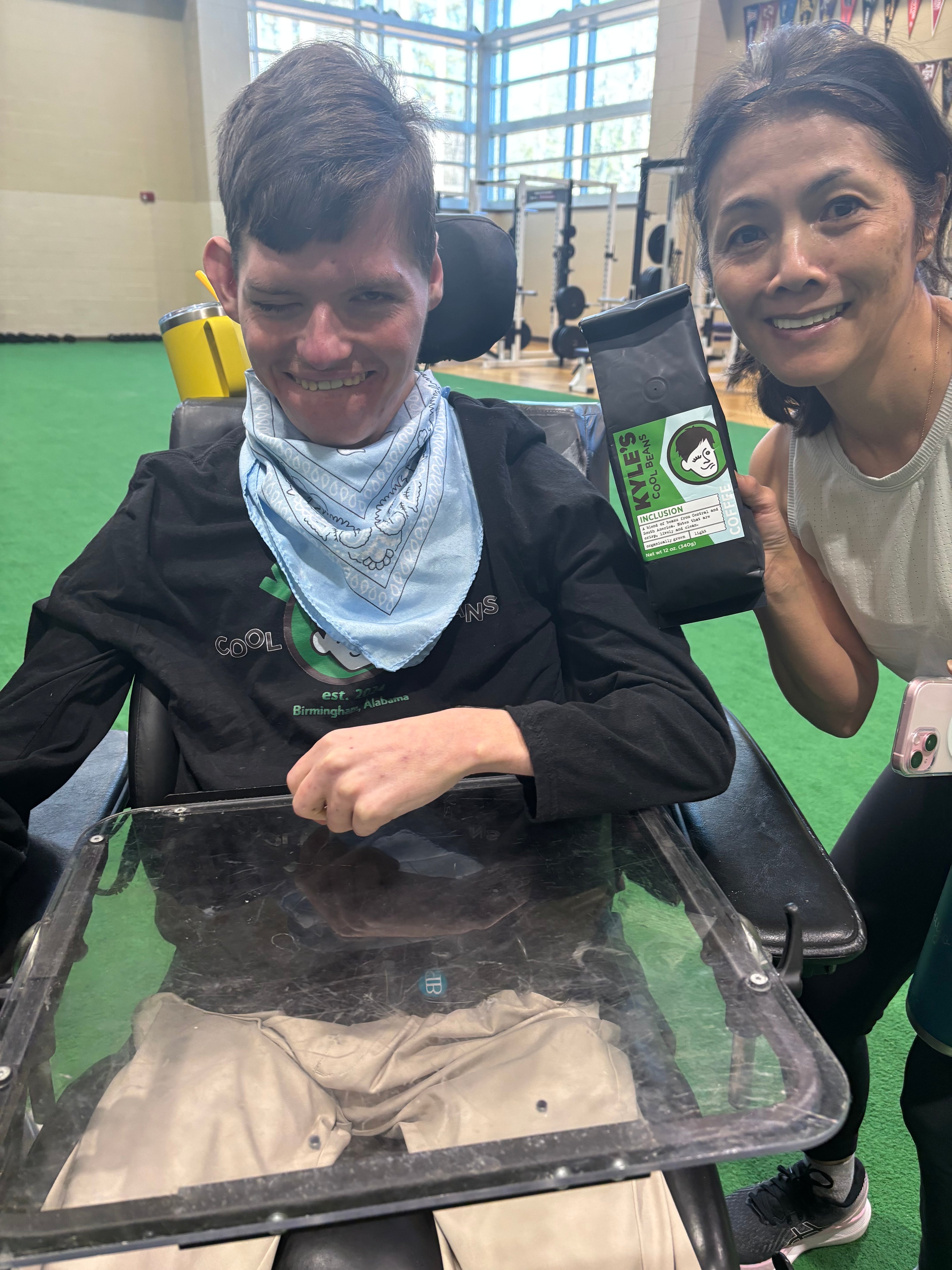 Kyle and a customer who just bought a bag of Kyle’s Inclusion Coffee