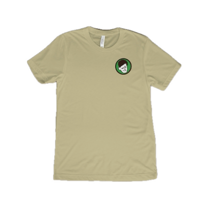 Sand KCB T-Shirt Front, sand shirt, Kyle’s face logo on the left 