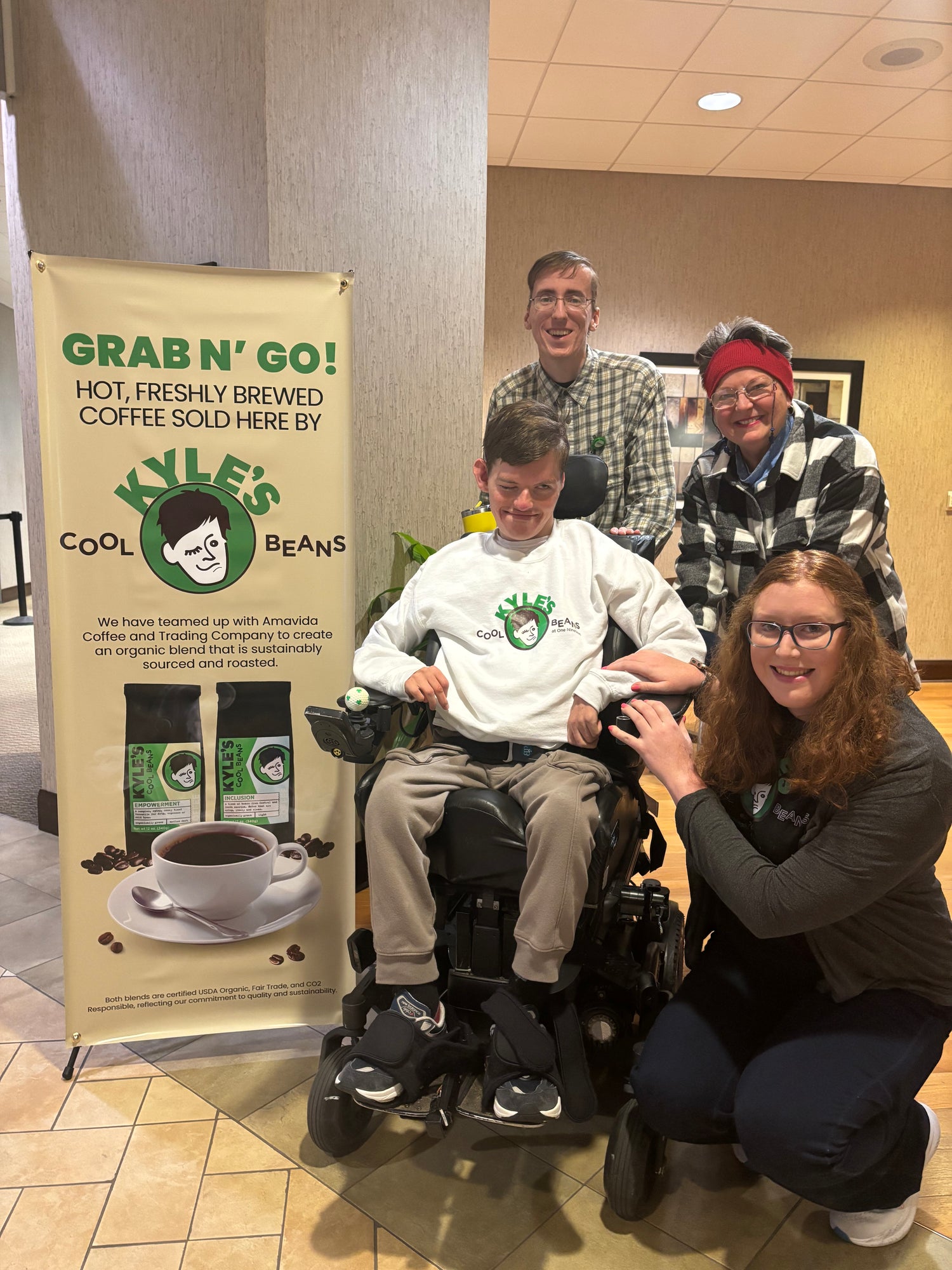 Kyle with his friends and customers at UAB St. Vincents. With a sign advertising his coffee.