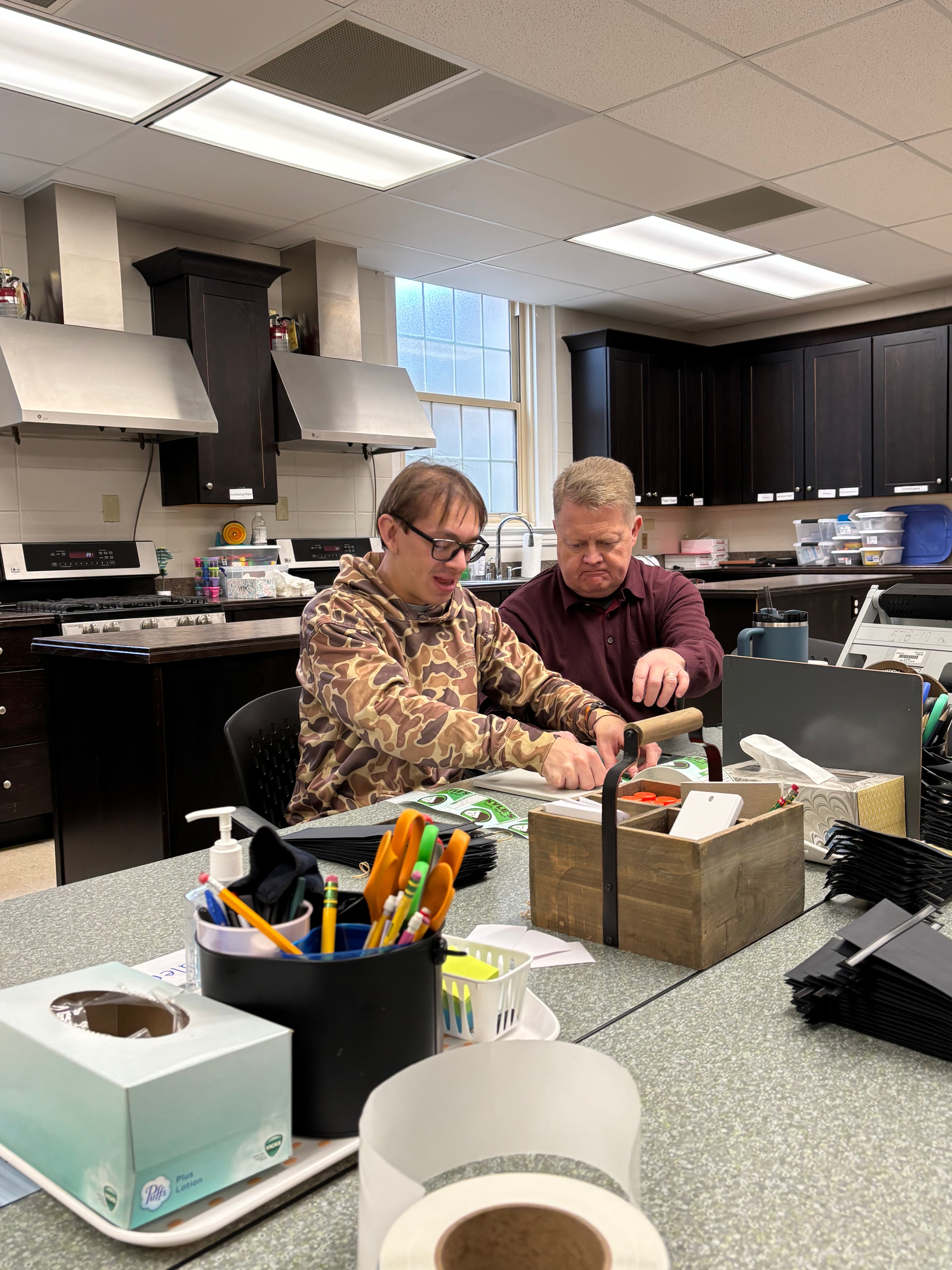One of Kyle’s friends applying stickers to coffee bags